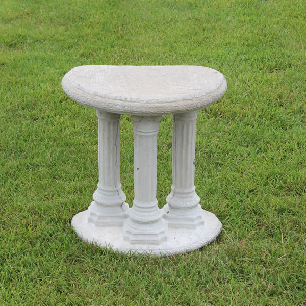 A solid base that has three decorative columns.