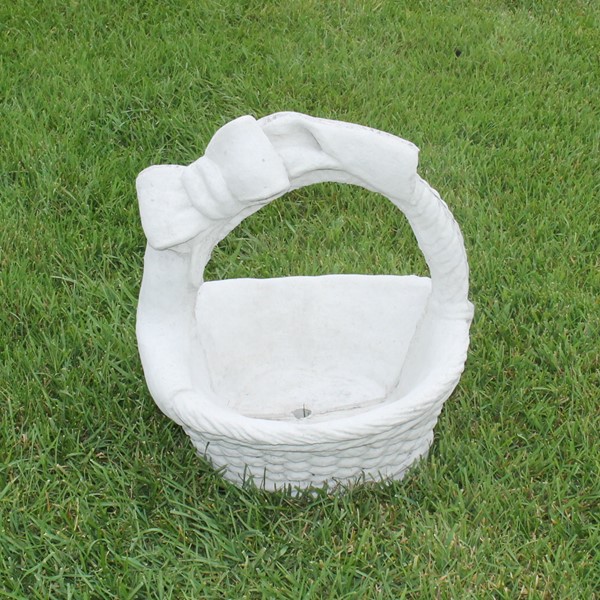A small woven look basket with a bow on the handle 
