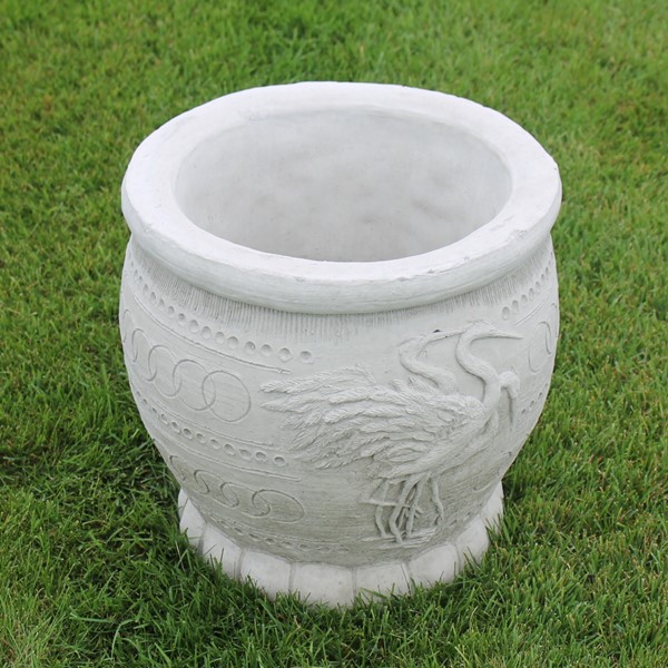 A round planter with an egret bird as a design around the exterior.