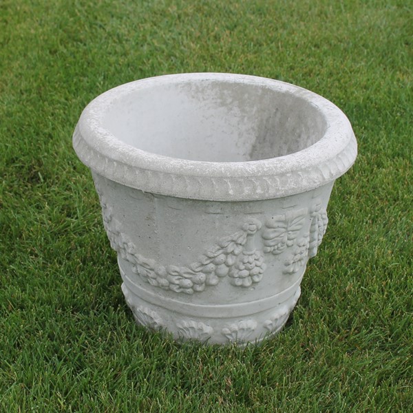 A medium planter with a swag vine design and grape like details.