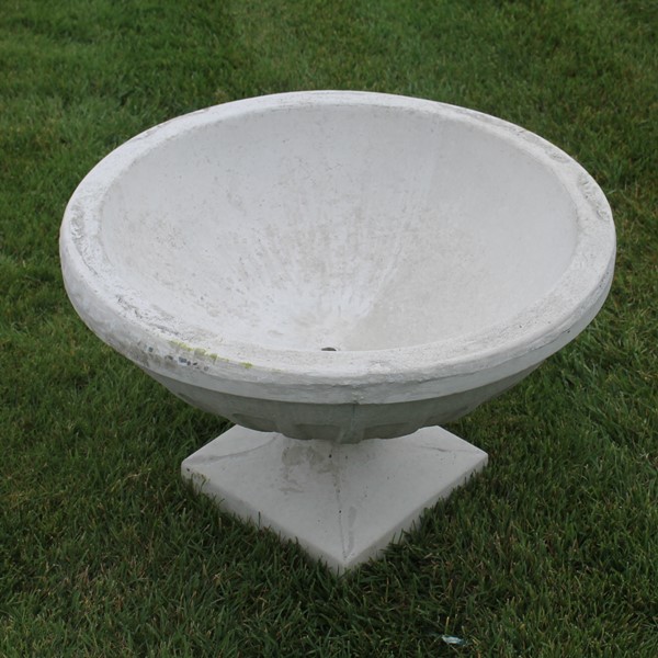 A bowl planter with a roman look to the design with a square bottom. 