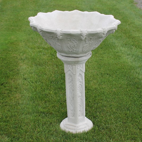 A tall planter set with a very detailed exterior. Two pieces, the large bowl and the tall pedestal. 