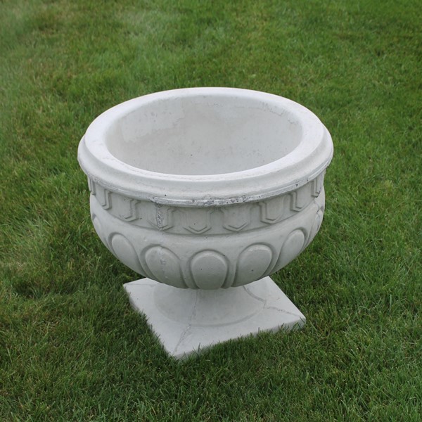 A large planter with an etched in and protruding designs.