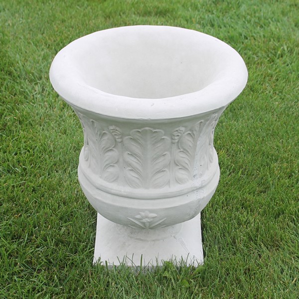 An urn style planter with a fern leaf design on the exterior