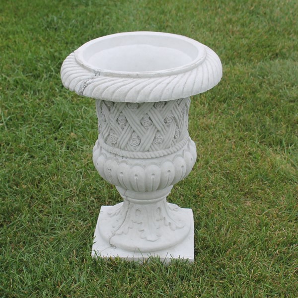 The urn style planter with small little rosettes and a lattice like design to the exterior.