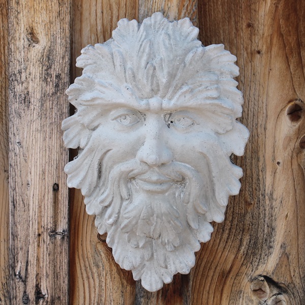A face seem to appear out of the greenery. This is the Green Man Plaque 